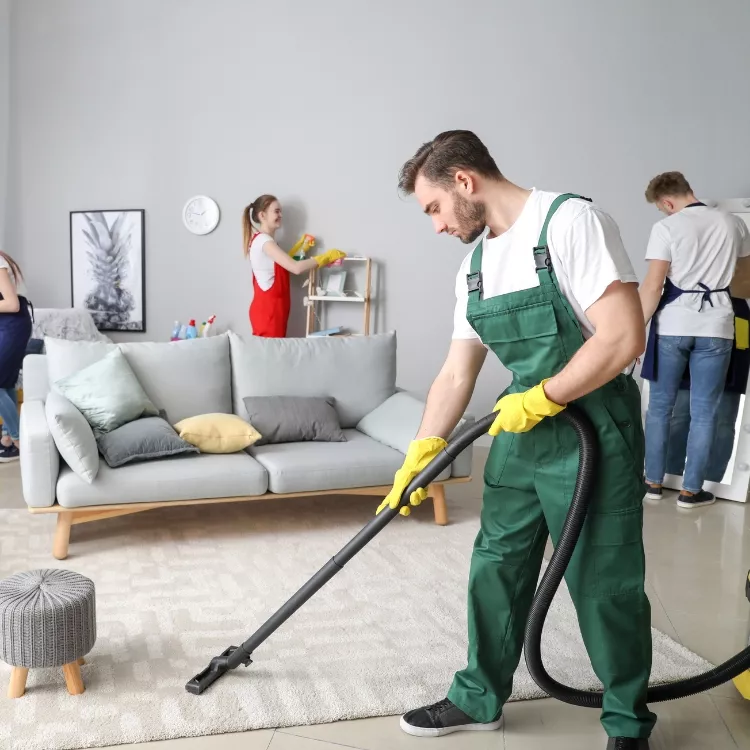 Vacuuming carpets during home cleaning services in Cowley